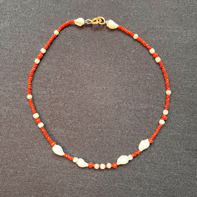 Ketting van koraal met  wulkjes.